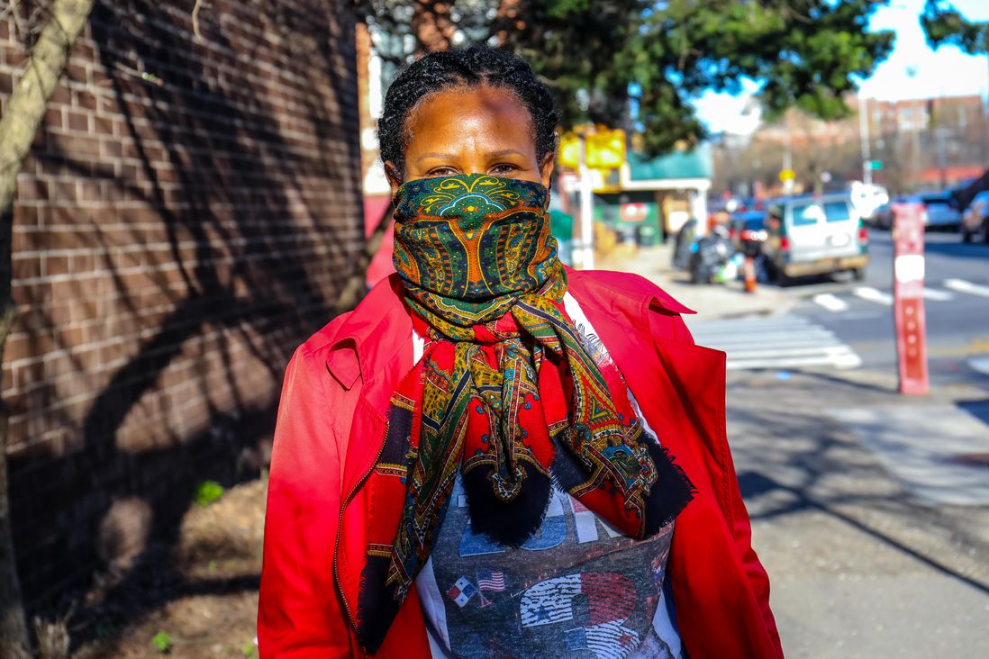 A woman wearing a scarf as a mask